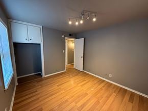 Tulsa house for rent - A room with wooden floors and a white door.