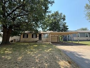 Tulsa house for rent - A house with a tree in front of it.