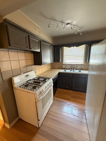Tulsa house for rent - A kitchen with a white stove and black cabinets.