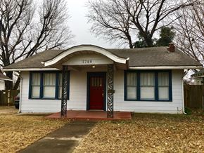 Tulsa house for rent - the front of a white house with a red door