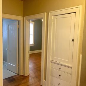 Tulsa house for rent - a bedroom with three doors and a dresser and a closet