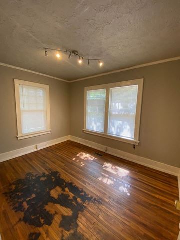 Tulsa house for rent - a living room with a hard wood floor and two windows