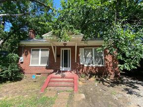 Tulsa house for rent - a brick house with a red front porch and a tree
