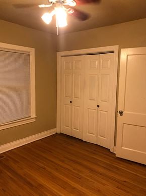 Tulsa house for rent - a bedroom with a door and a closet and a window