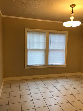 Tulsa house for rent - a dining room with two windows and a tiled floor