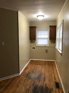 Tulsa house for rent - a living room with wood floors and a window