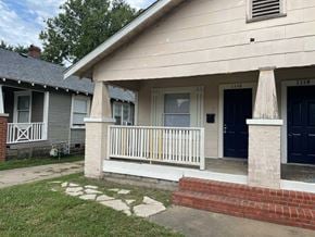 Tulsa house for rent - the front porch of a house with a porch swing