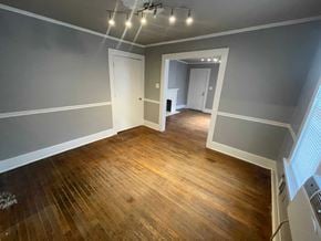 Tulsa house for rent - a living room with a hard wood floor and gray walls