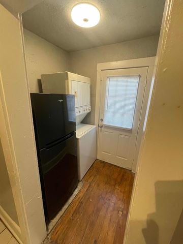 Tulsa house for rent - a small kitchen with a refrigerator and a door