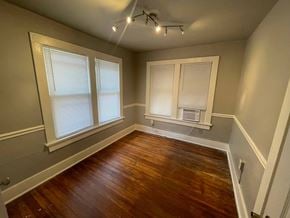Tulsa house for rent - a living room with a hard wood floor and windows