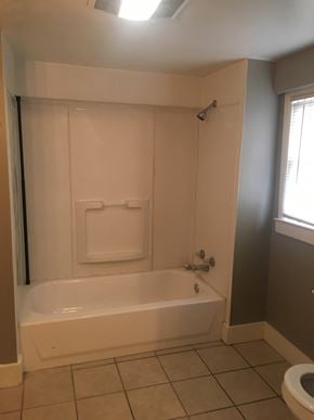 Tulsa house for rent - a bathroom with a tub and a toilet and a window