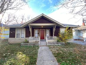 Tulsa house for rent - a house with a red door and a sidewalk in front of it
