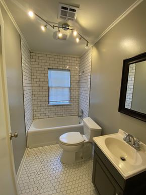 Tulsa house for rent - a bathroom with a toilet and a tub and a sink