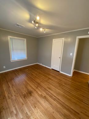 Tulsa house for rent - a living room with a hard wood floor and grey walls