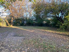 Tulsa house for rent - an open field with trees and a dirt road