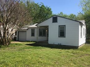 Tulsa house for rent - a white house with a yard and a tree