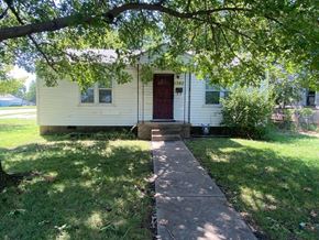 Tulsa house for rent - a white house with a sidewalk in front of it