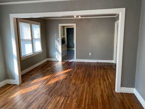 Tulsa house for rent - an empty living room with a hard wood floor