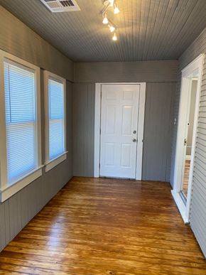Tulsa house for rent - a room with a wooden floor and a white door