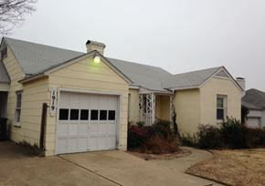 Tulsa house for rent - a white house with a garage and a light on it