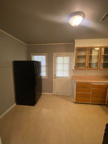 Tulsa house for rent - a kitchen with a refrigerator and some cabinets