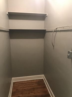 Tulsa house for rent - A white shelf is on the wall above a wooden floor.