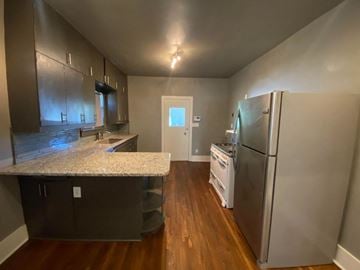 Tulsa house for rent - a kitchen with a counter top and a refrigerator