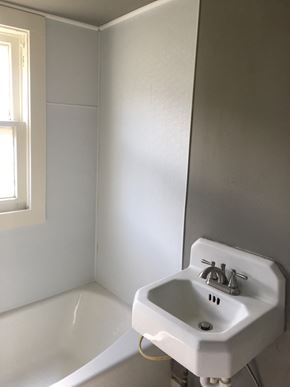 Tulsa house for rent - A white sink in a bathroom with a window.