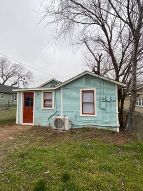 Tulsa house for rent - A blue house with a red door and two air conditioning units.