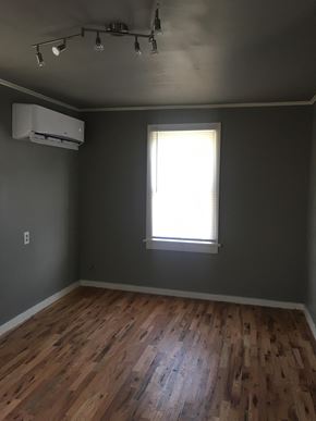 Tulsa house for rent - A room with a window and wooden flooring.