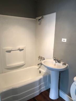 Tulsa house for rent - a bathroom with a sink and a bath tub and a mirror