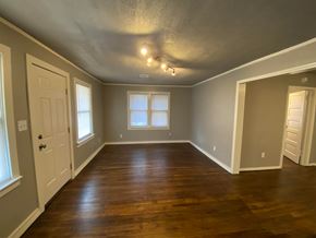 Tulsa house for rent - A room with wooden floors and white doors.