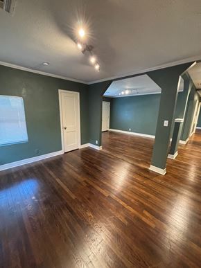 Tulsa house for rent - A room with wooden flooring and a white door.