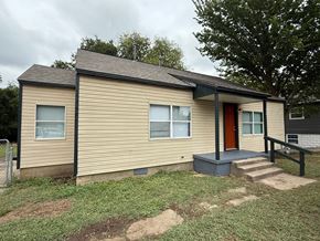 Tulsa house for rent - A small house with a red door and a brown roof.