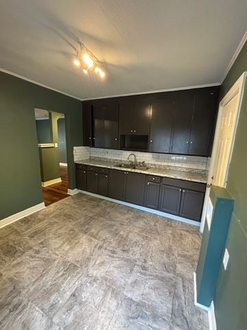 Tulsa house for rent - A kitchen with black cabinets and a green wall.