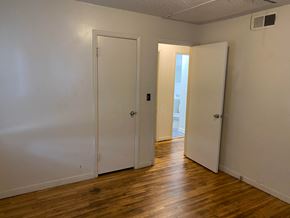 Tulsa house for rent - a bedroom with two closets and a door to a bathroom