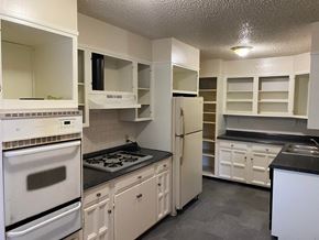 Tulsa house for rent - a kitchen with white appliances and white cabinets