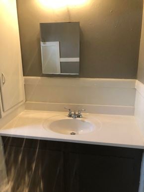 Tulsa house for rent - a bathroom with a sink and a mirror