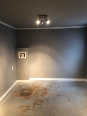 Tulsa house for rent - an empty room with a blue wall and a white floor and a ceiling fan