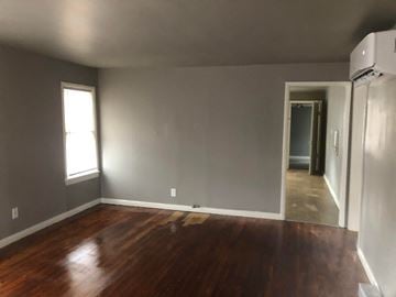 Tulsa house for rent - a living room with a hard wood floor and grey walls