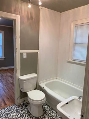 Tulsa house for rent - a small bathroom with a toilet and a bath tub