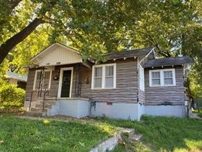 Tulsa house for rent - a small house with a tree in front of it