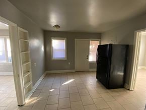 Tulsa house for rent - an empty living room with a black refrigerator