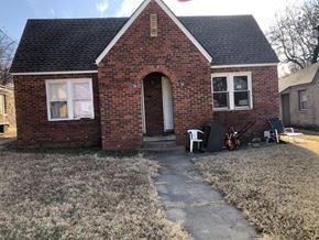 Tulsa house for rent - a small brick house with a front yard and a porch