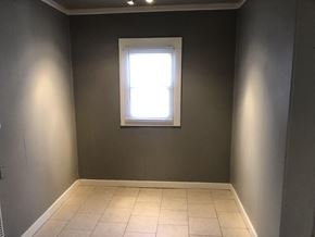 Tulsa house for rent - an empty room with a window and a tiled floor