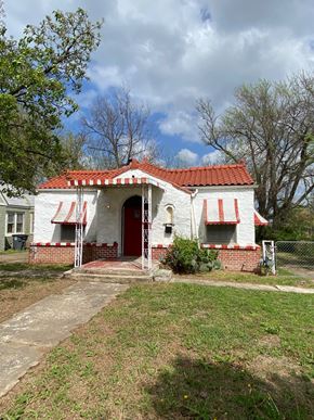 Tulsa house for rent - A white house with a red roof and a red door.