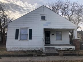 Tulsa house for rent - the front of a white house with blue shutters