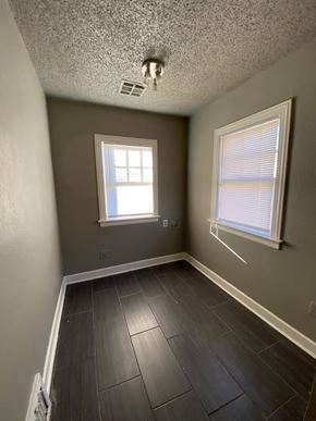 Tulsa house for rent - A room with a window and a ceiling fan.
