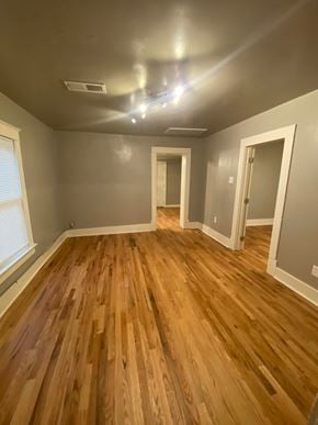 Tulsa house for rent - a living room with wooden floors and grey walls