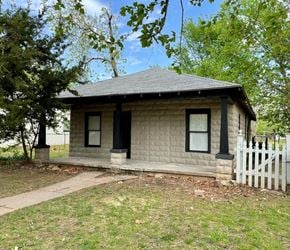 Tulsa house for rent - a small white house with a white picket fence
